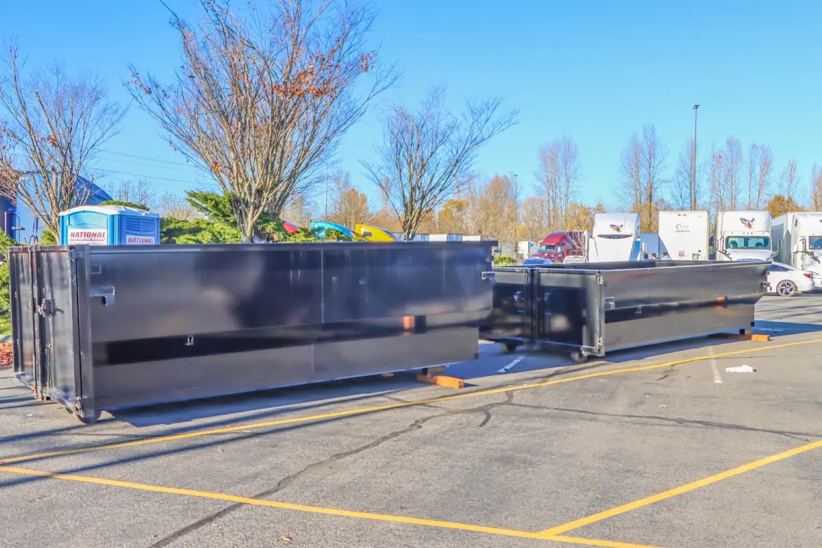 Professional dumpster rental service with roll-off container on residential driveway in Porterville